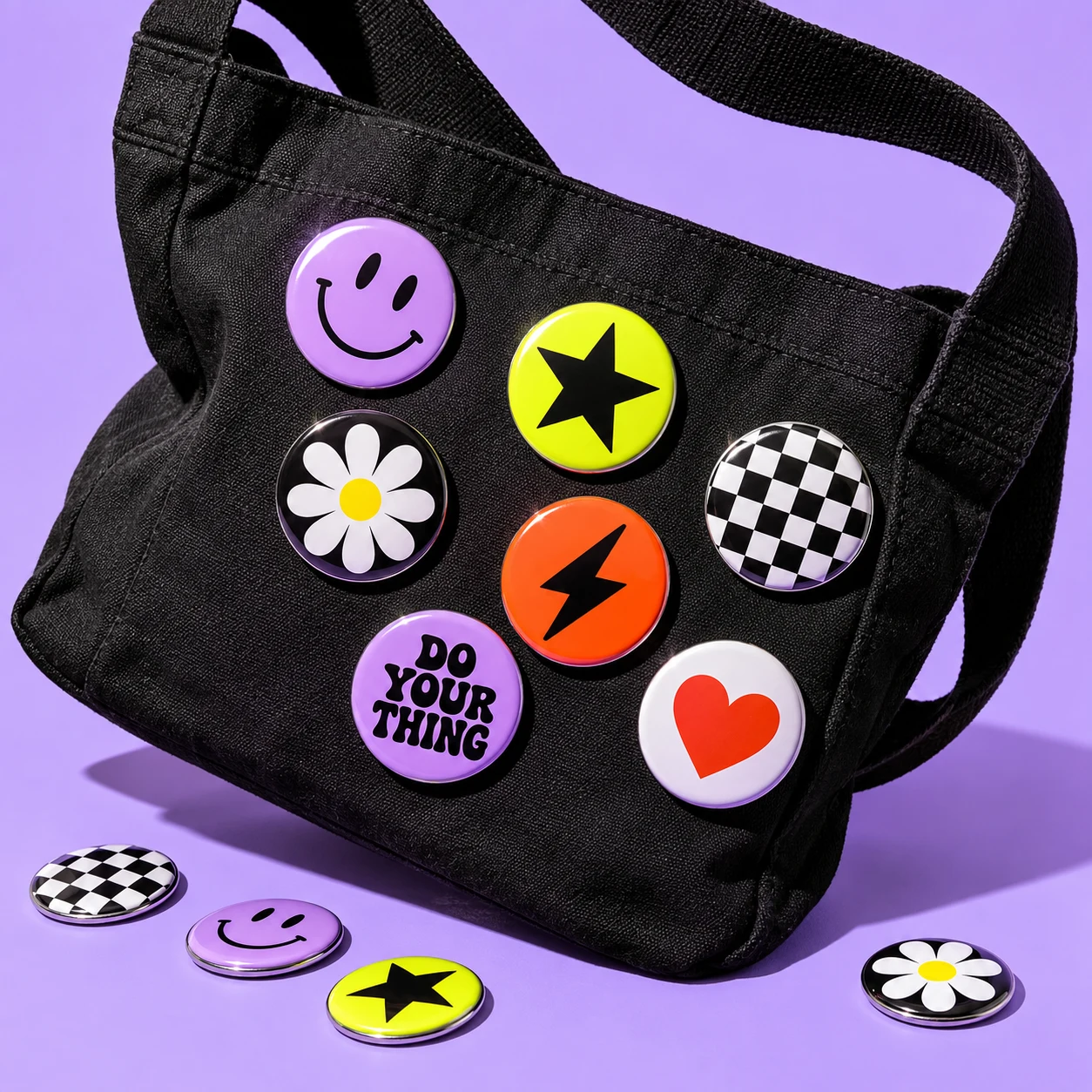Colourful badges pinned to a black bag